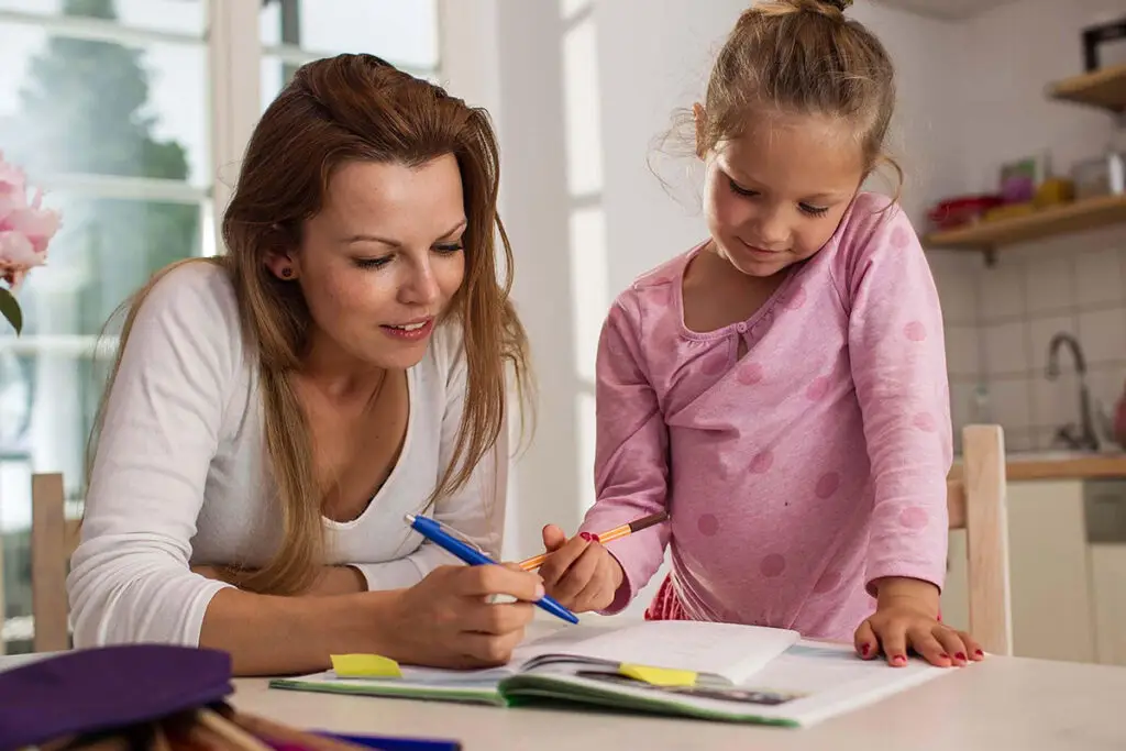 carer helping a young child at home